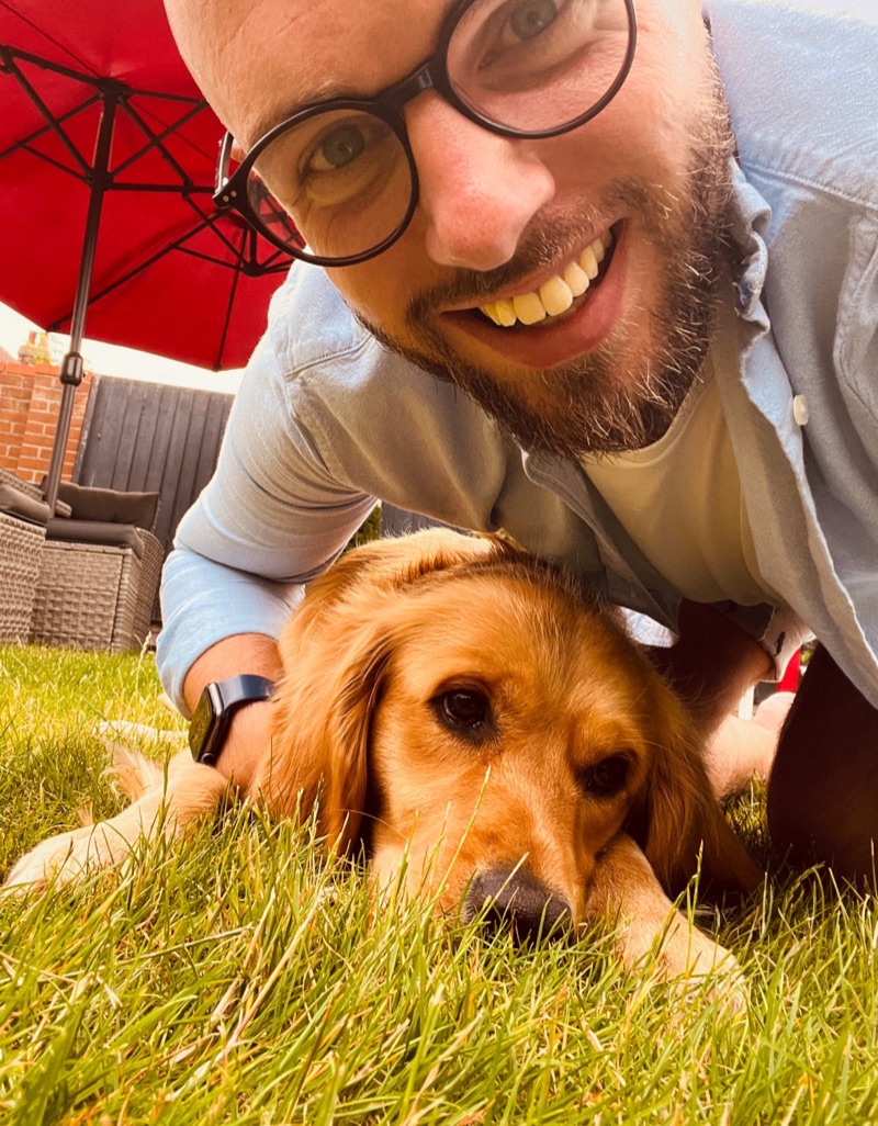 Max smiling in the garden with his dog